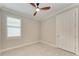 Bright, clean bedroom featuring modern wood-look tile floor and ceiling fan at 257 Teramo Way, Nokomis, FL 34275