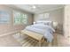 Light-filled bedroom boasts neutral tones, a ceiling fan, and a calming aesthetic, perfect for relaxation at 257 Teramo Way, Nokomis, FL 34275