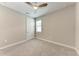 Bedroom features carpet, a ceiling fan, and a window that provides natural light at 257 Teramo Way, Nokomis, FL 34275