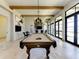 Billiards room with stylish lighting, wood beams, and lake views at 257 Teramo Way, Nokomis, FL 34275