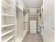 Well-organized walk-in closet with ample shelving and hanging space provides optimal storage solutions at 257 Teramo Way, Nokomis, FL 34275