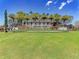 The Toscana Isles community entrance is marked by a stone sign, colorful flowers, and manicured landscaping at 257 Teramo Way, Nokomis, FL 34275