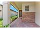Covered entrance with brick paving and stone accents by front door at 257 Teramo Way, Nokomis, FL 34275