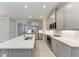 Well-lit kitchen featuring quartz counters, stainless steel appliances, and gray cabinets at 257 Teramo Way, Nokomis, FL 34275