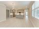 Spacious open-concept kitchen features grey cabinets, stainless appliances, a center island, and stylish pendant lighting at 257 Teramo Way, Nokomis, FL 34275