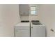 Laundry room includes washer and dryer and overhead cabinets at 257 Teramo Way, Nokomis, FL 34275