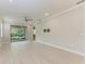 Spacious living room with wood look floors and sliders to outdoor patio at 257 Teramo Way, Nokomis, FL 34275