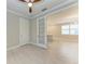 Bright living area featuring wood-look tile, with view of modern kitchen through glass paneled door at 257 Teramo Way, Nokomis, FL 34275