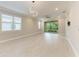 Open living area with tile flooring, modern lighting, and sliding glass doors to the outdoors at 257 Teramo Way, Nokomis, FL 34275