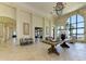 Grand lobby featuring high ceilings, stone accents, elegant chandelier, and lake views at 257 Teramo Way, Nokomis, FL 34275