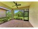 Covered patio with brick floors and views of the landscaped backyard at 257 Teramo Way, Nokomis, FL 34275