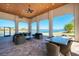 Large covered patio with comfortable seating overlooking the lake at 257 Teramo Way, Nokomis, FL 34275
