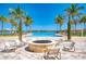 Community pool with a fire pit lounge area and palm trees overlooking the lake at 257 Teramo Way, Nokomis, FL 34275