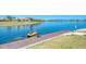 Dockside view of resident kayaking on community lake at 257 Teramo Way, Nokomis, FL 34275