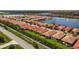 A high aerial view of homes with red roofs along a lakefront community at 260 Soliera St, Nokomis, FL 34275
