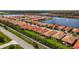 A panoramic aerial view of a residential area near a lake, with houses and streets at 260 Soliera St, Nokomis, FL 34275