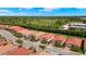 Aerial view of a residential neighborhood featuring well-maintained homes, red tiled roofs, and lush greenery at 260 Soliera St, Nokomis, FL 34275