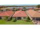 Aerial view of a home with a red tile roof, overlooking a well-maintained lawn and lush landscaping at 260 Soliera St, Nokomis, FL 34275