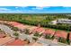 Aerial view of a residential neighborhood featuring well-maintained homes, red tiled roofs, and lush greenery at 260 Soliera St, Nokomis, FL 34275