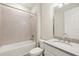 Well-lit bathroom with a tiled shower-tub combo and a stylish vanity at 260 Soliera St, Nokomis, FL 34275
