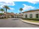 A well-kept clubhouse with palm trees, a covered entrance, and tidy landscaping at 260 Soliera St, Nokomis, FL 34275
