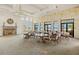 Clubhouse space with stone accent wall, fireplace, chandelier and views of the lake at 260 Soliera St, Nokomis, FL 34275