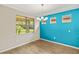 Dining room with bright accent wall and large windows with beautiful outside view at 260 Soliera St, Nokomis, FL 34275