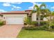 Lovely home with a two-car garage, mature landscaping, and a welcoming front entrance at 260 Soliera St, Nokomis, FL 34275