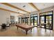 Game room with a pool table, bar area, tile flooring, and expansive windows overlooking the scenery at 260 Soliera St, Nokomis, FL 34275