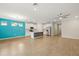 Open kitchen and living area with a bright accent wall and stainless steel appliances at 260 Soliera St, Nokomis, FL 34275