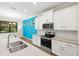 Stylish kitchen featuring a center island, stainless steel appliances, and white cabinetry at 260 Soliera St, Nokomis, FL 34275