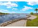 Scenic lake view with a walking path lined by rocks and lush greenery at 260 Soliera St, Nokomis, FL 34275