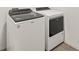 Modern white Whirlpool washer and dryer set in a well-lit laundry area at 260 Soliera St, Nokomis, FL 34275