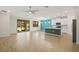 Open-concept living space with modern kitchen and access to outdoor patio at 260 Soliera St, Nokomis, FL 34275