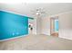 Main bedroom with bright accent wall, ceiling fan, and adjoining bathroom at 260 Soliera St, Nokomis, FL 34275