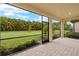 Screened patio features brick flooring and a lovely view of the green lawn and landscaping at 260 Soliera St, Nokomis, FL 34275
