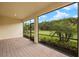 Screened patio with brick flooring offers a peaceful view of the backyard at 260 Soliera St, Nokomis, FL 34275
