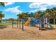 A colorful and fun playground area with slides, climbing structures, and a wood chip ground at 260 Soliera St, Nokomis, FL 34275