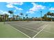 Well-maintained tennis courts with lighting for evening play amidst a tropical setting at 260 Soliera St, Nokomis, FL 34275