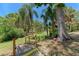 Lush backyard with mature trees, and a wood footbridge at 2718 Orchid Oaks Dr # C-202, Sarasota, FL 34239
