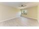 Bedroom features tile flooring, ceiling fan, and natural light at 2718 Orchid Oaks Dr # C-202, Sarasota, FL 34239