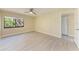 This bedroom features updated floors and a large window at 2718 Orchid Oaks Dr # C-202, Sarasota, FL 34239