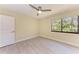 Bedroom features tile flooring, ceiling fan, and a large window at 2718 Orchid Oaks Dr # C-202, Sarasota, FL 34239