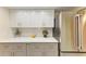 Close-up of kitchen counter with white cabinets, stainless steel appliances, and modern backsplash at 2718 Orchid Oaks Dr # C-202, Sarasota, FL 34239