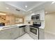 Stylish kitchen with stainless appliances, white cabinets, ample counter space, and bar seating at 2718 Orchid Oaks Dr # C-202, Sarasota, FL 34239