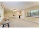 Open-concept living room with tile flooring, built-in bar and a large window at 2718 Orchid Oaks Dr # C-202, Sarasota, FL 34239
