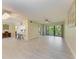 Open-concept living room with breakfast bar, tile flooring and patio access at 2718 Orchid Oaks Dr # C-202, Sarasota, FL 34239