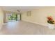 Living room with tile flooring, ceiling fan and access to outdoor patio at 2718 Orchid Oaks Dr # C-202, Sarasota, FL 34239