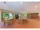 Spacious living room with large windows, ample seating, and a dining area at 2718 Orchid Oaks Dr # C-202, Sarasota, FL 34239