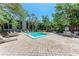 Inviting community pool area with lounge chairs and shade at 2718 Orchid Oaks Dr # C-202, Sarasota, FL 34239
